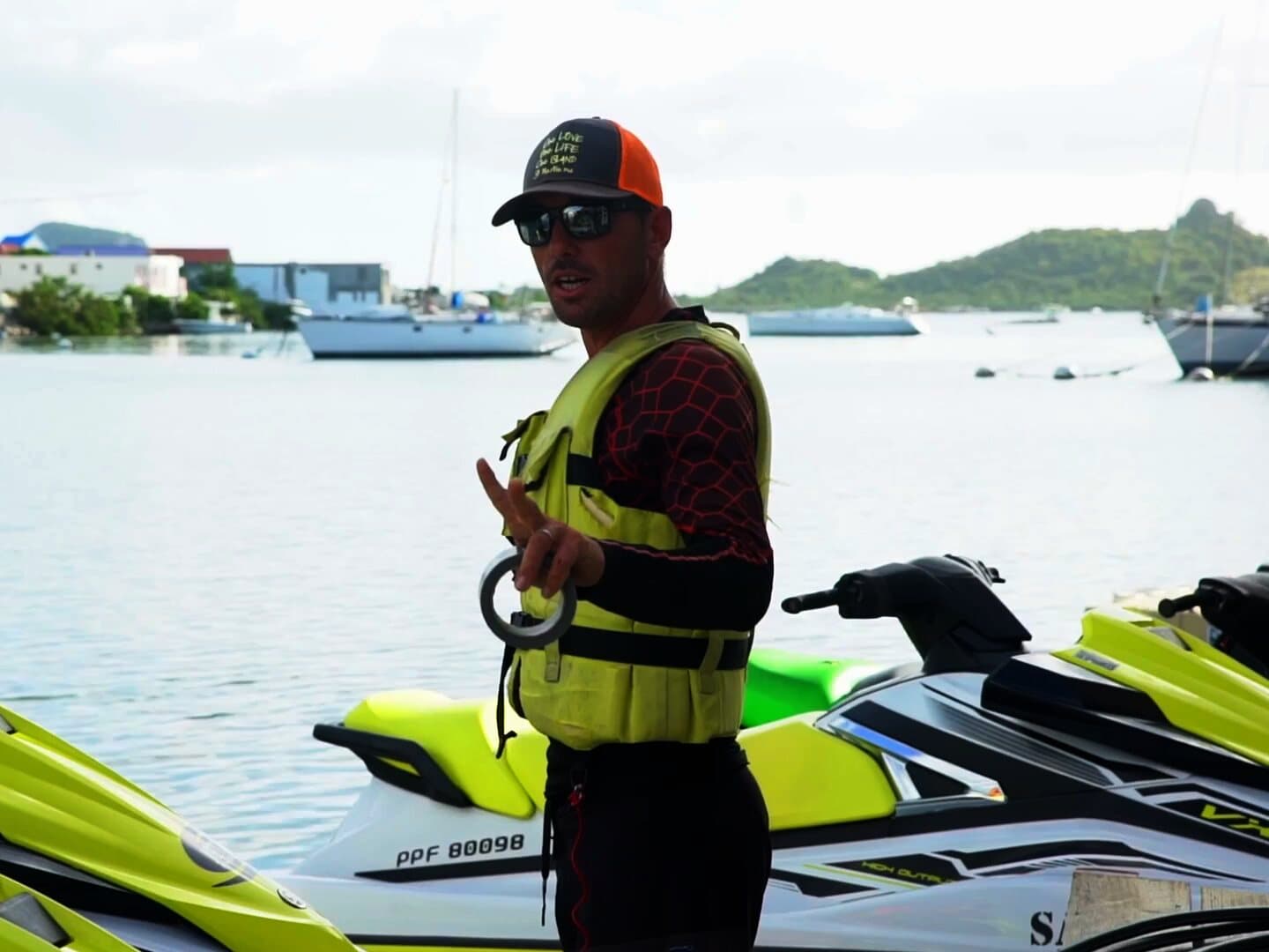 A Jet Paradise guide in a life vest on the Marina Royale pontoon